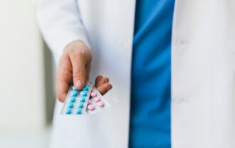 Doctor holding pills